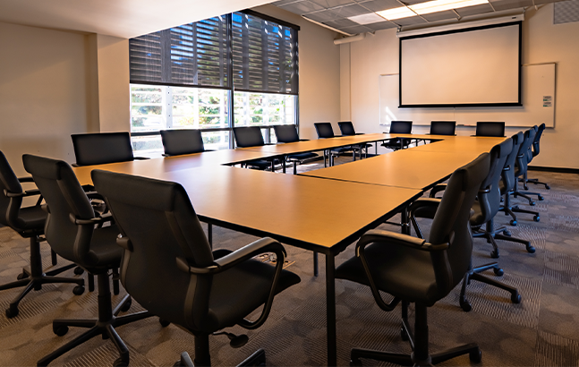 Conference room with a table surrounded by chairs.