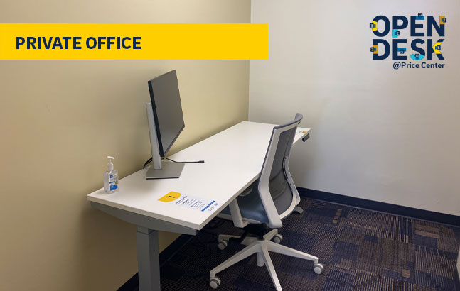 desk, chair and power box in small room